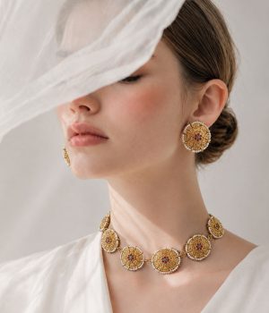 Vintage gold-tone Nigar choker set with central floral design, white bead edging and matching earrings