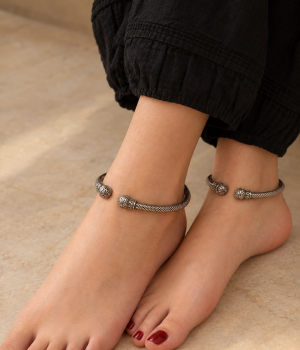 Antique oxidized carved foot cuff with a dark patina and open C-shaped design